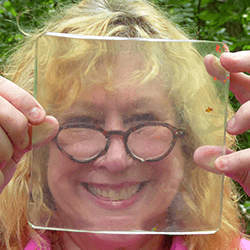 Denise holding up a gelatin plate, used for gelatin printing.